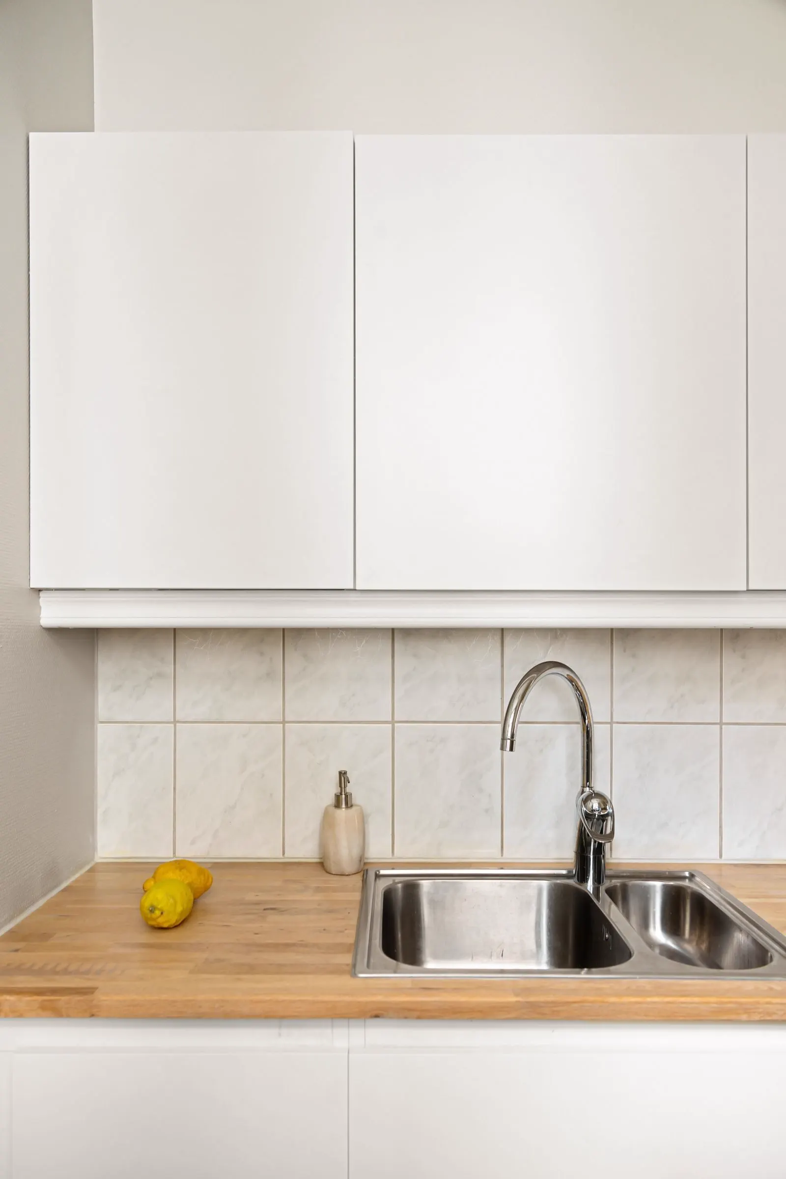 Kitchen sink with a gooseneck faucet and a tile backsplash